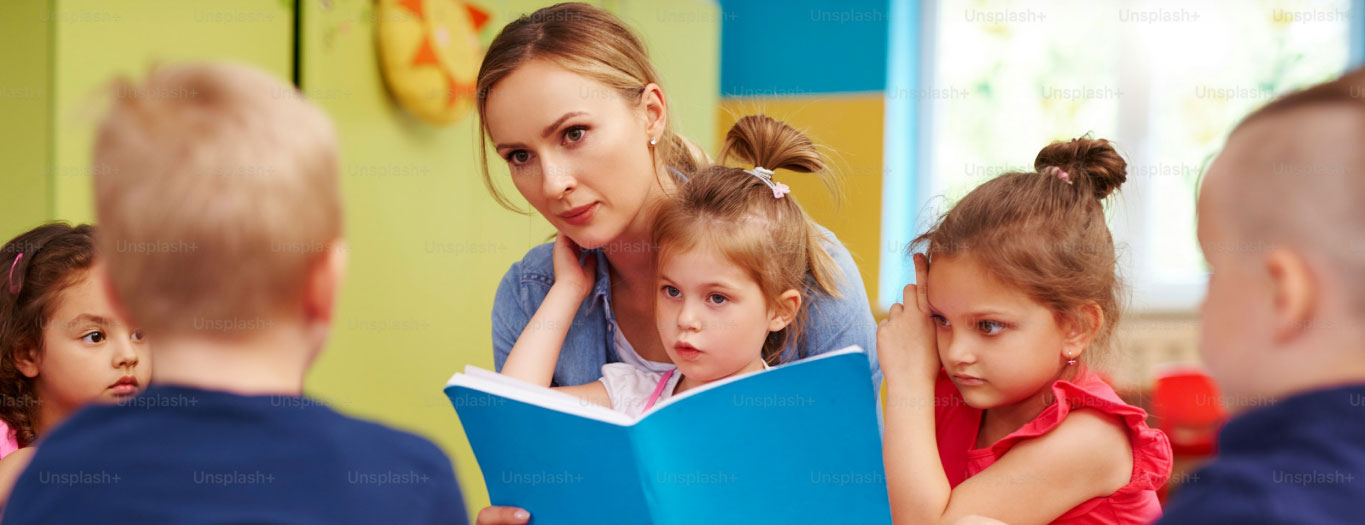 Woman reading book to children